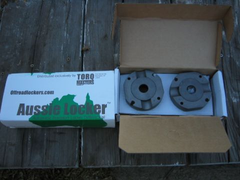 1973 Ford F-100 - Two differential locker components are shown inside their opened box, alongside the product packaging.