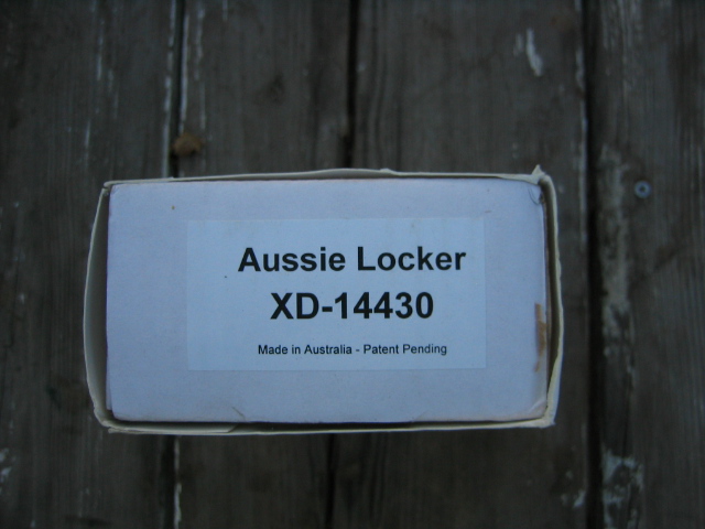Cardboard box labeled Aussie Locker XD-14430, Made in Australia - Patent Pending, on wooden surface