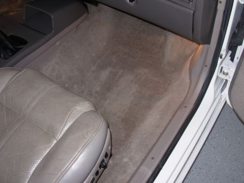1995 Ford Taurus - Interior view of a 1995 Ford Taurus, highlighting the driver's seat and floor carpeting.