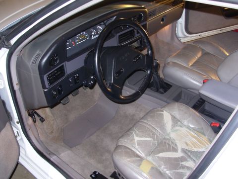 1995 Ford Taurus - Interior view of a 1995 Ford Taurus, highlighting the dashboard and worn driver's seat.