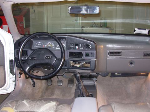 1995 Ford Taurus - The interior of a car is shown, focusing on the dashboard and driver's controls. The "SHO" emblem is visible on the steering wheel.