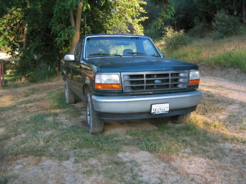 1973 Ford F-100 - This Ford F-150 pickup truck is seen from the front, parked in a grassy area.