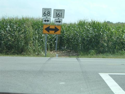 1995 Mercury Grand Marquis - Roadside signs indicate Indiana routes 68 and 161, with a large cornfield bordering the road.