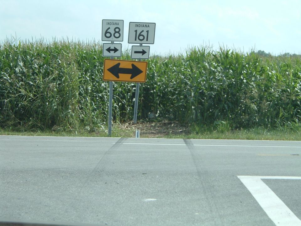 Roadside signs for Indiana 68 and 161 with a cornfield backdrop