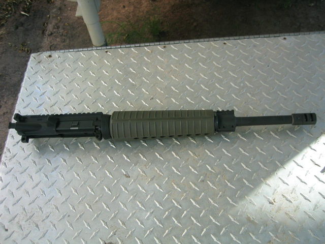 AR-15 upper receiver with green handguard and barrel assembly on diamond plate
