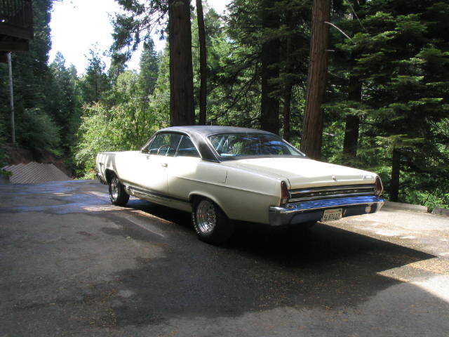 White 1968 coupe with black vinyl top, rear 3/4 view