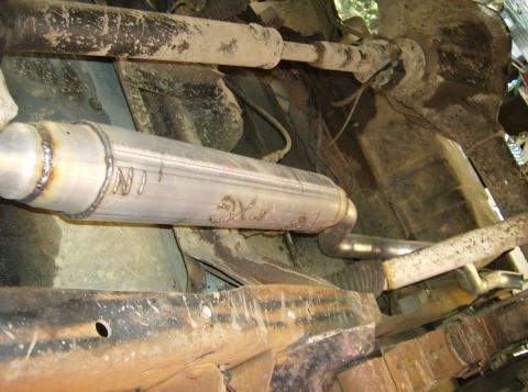 1986 Ford Bronco - Custom exhaust muffler with visible welds and etched markings, likely a replacement part.
