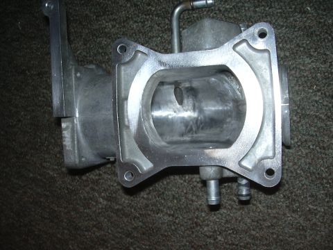 1996 Ford Crown Victoria - Close-up view of a throttle body, likely for an older vehicle, showing the internal bore and mounting flange.