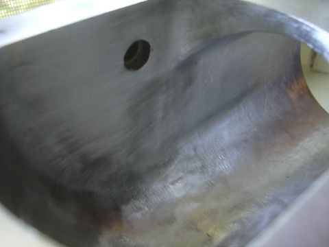 1996 Ford Crown Victoria - This is a close-up view of a metal engine intake plenum, showing a circular opening.
