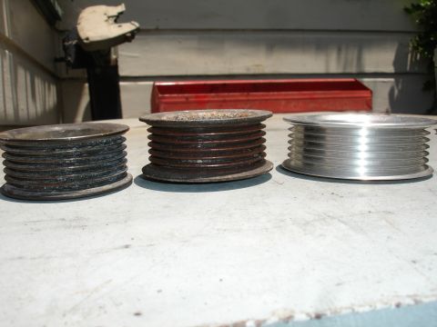 1993 Ford Taurus - Comparison of three different pulleys, showing varying states of wear and material.