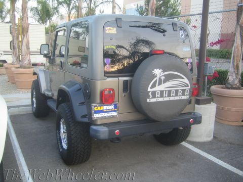 1987 Suzuki Samurai - This Jeep Wrangler Sahara Edition is seen from the rear in a parking lot.