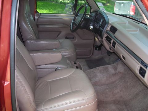 1995 Ford Bronco - Interior view of a 1995 Ford Bronco, showing the tan leather seats and dashboard.
