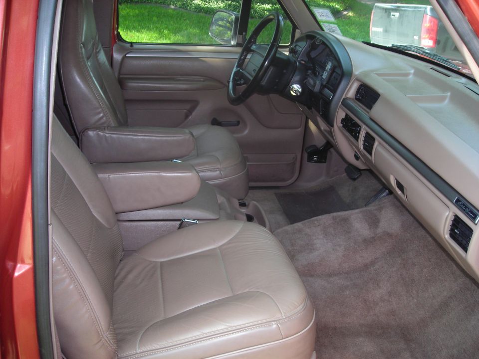 Tan leather seats and dashboard of a 1995 Ford Bronco, viewed from the passenger side