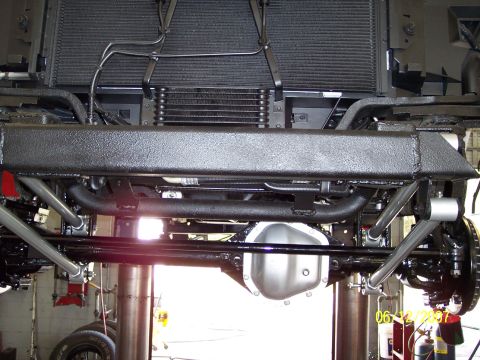 1996 Ford Bronco - Close-up of a vehicle's undercarriage, focusing on the suspension and drivetrain components.