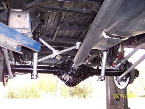 1996 Ford Bronco - The undercarriage of a vehicle is shown, highlighting the rear axle and suspension components.