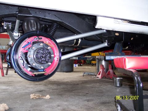 1996 Ford Bronco - Close-up of a vehicle's rear axle and suspension system during maintenance.