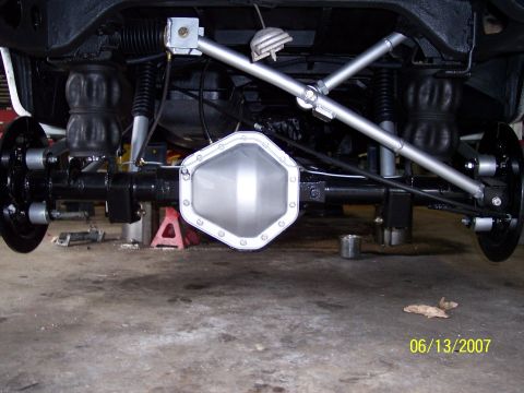 1996 Ford Bronco - Underside view of a vehicle's rear axle and suspension system.