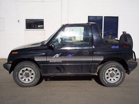 1995 Ford Bronco - This black 2-door SUV features 'Sidekick' and '4x4' decals on its side.