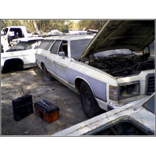 1973 Ford Ranchero - Junkyard scene with a 1973 Ford station wagon and other vehicles.
