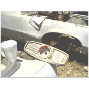 1973 Ford Ranchero - A disassembled tail light assembly is shown with a white cup nearby.