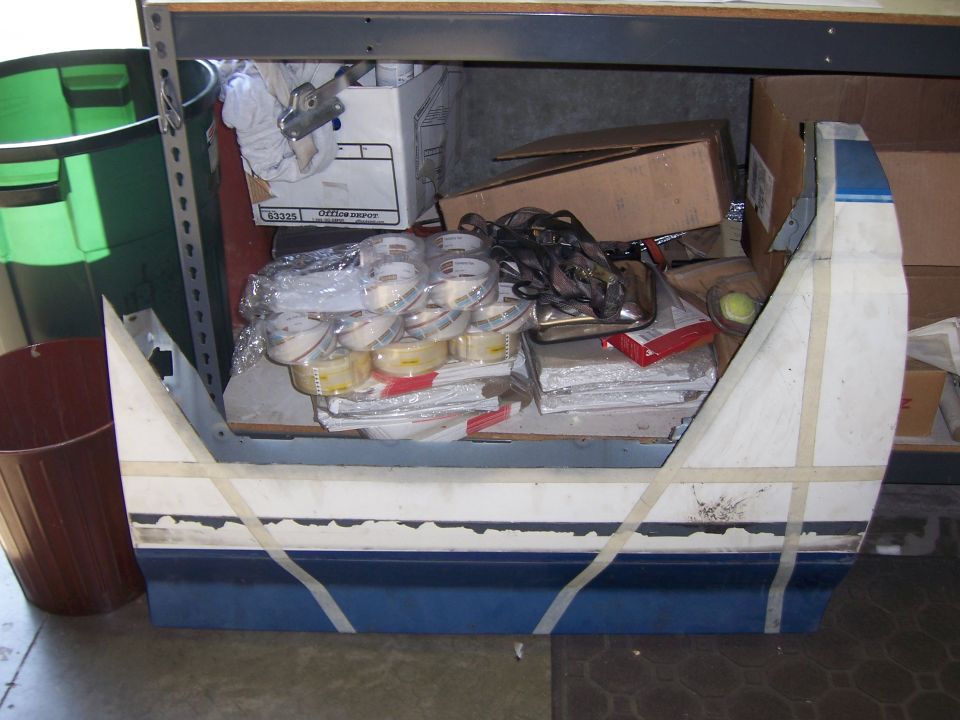 Blue and white vehicle body part with tape