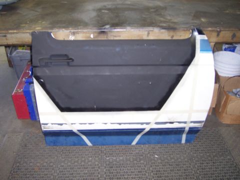 1991 Ford Bronco - Ford Bronco door undergoing modification, taped for prep work.