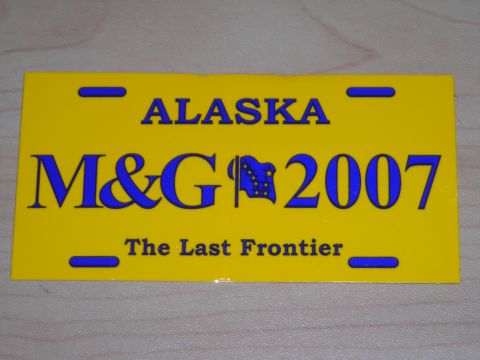 2003 Jeep TJ - This is a yellow Alaska license plate with blue lettering that reads 'ALASKA M&G 2007 The Last Frontier'.
