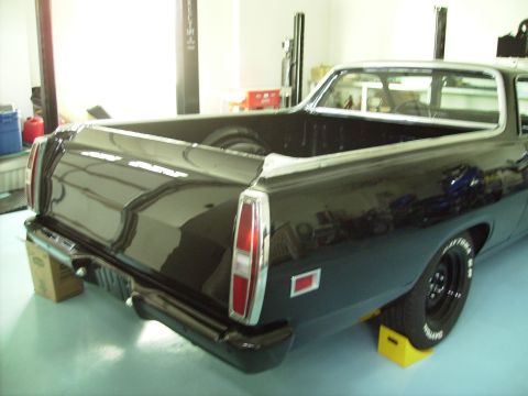 1970 Ford Ranchero - Rear view of a black 1970 Ford Ranchero, its distinctive taillights and chrome bumper.