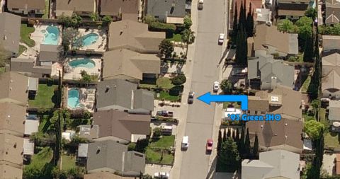 1993 Ford Taurus - An aerial view shows a suburban street with multiple cars and houses, with a label indicating a '93 Green SHO'.