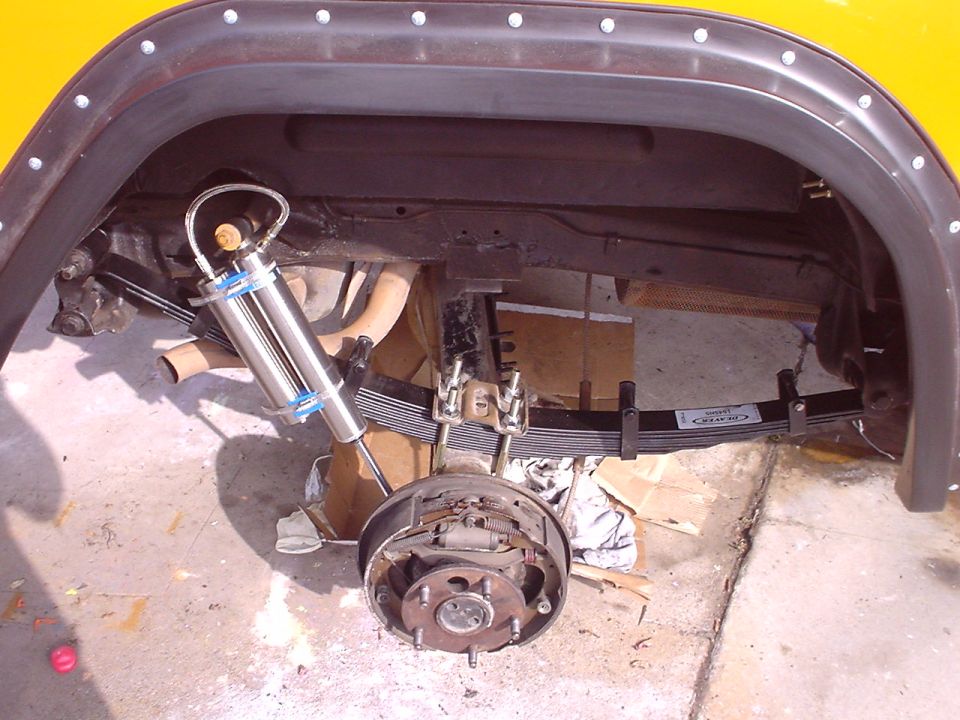 Rear suspension of a 1977 Ford Bronco showing leaf springs and a new shock absorber