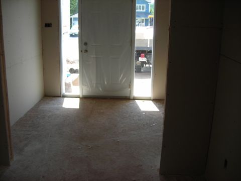 1984 Ford Bronco - A truck is visible through an open door, with construction materials inside the foreground.