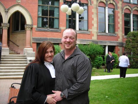 1984 Ford Bronco - A couple smiles for a photo in front of a large brick building, possibly after a graduation ceremony.