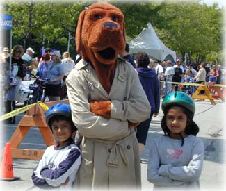 1995 Dodge 1500 - A person in a dog mascot costume poses with two children at an outdoor event.