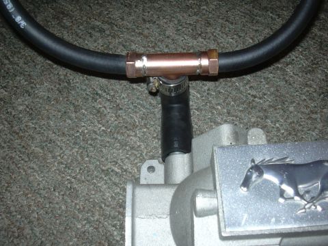 1996 Ford Crown Victoria - A close-up shows a Ford Mustang intake manifold with a hose connected via a copper T-fitting.