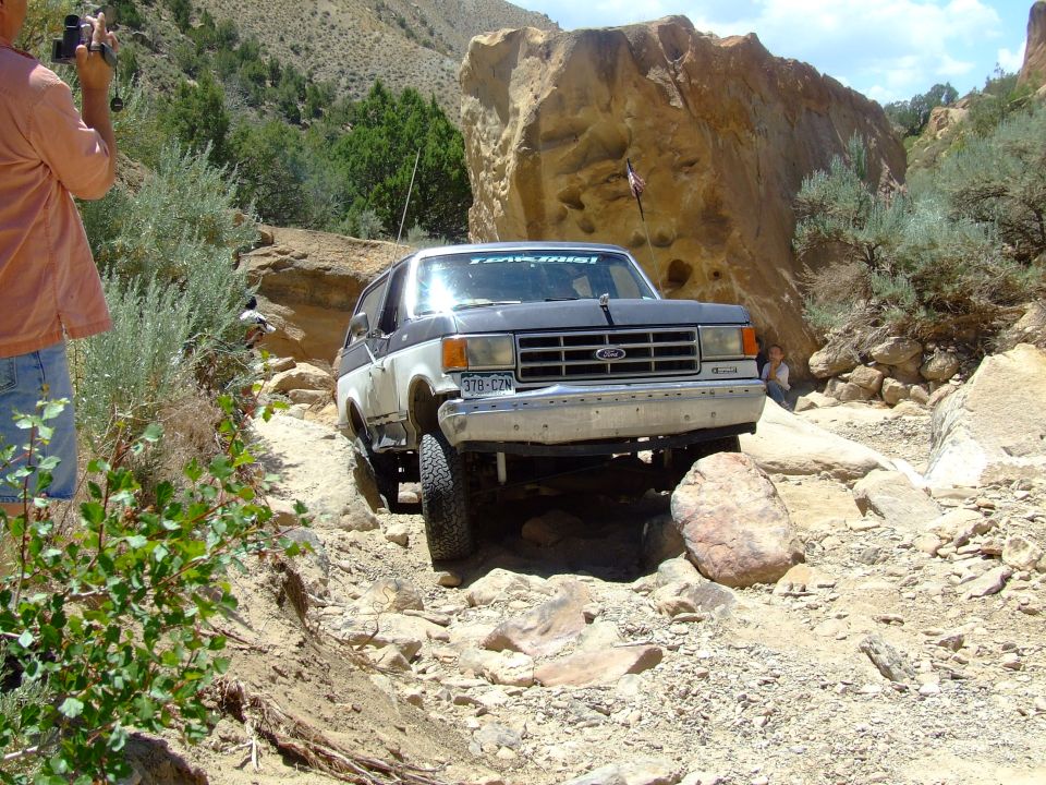 1987 Ford Bronco navigating a rocky trail