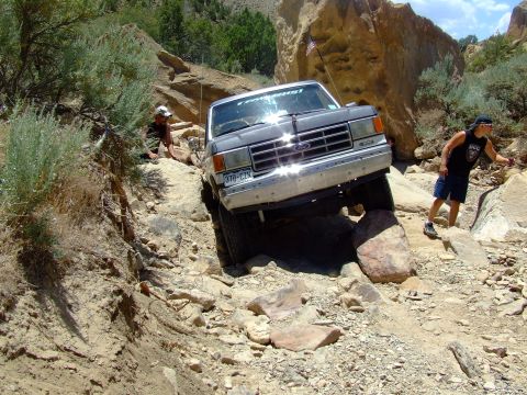 1987 Ford Bronco - This 1987 Ford Bronco tackles a challenging off-road trail with a driver and spotter present.