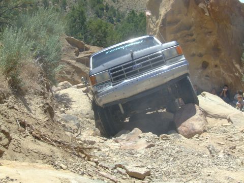 1987 Ford Bronco - Ford Bronco tackling a challenging off-road course on rocks.