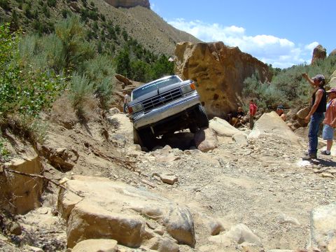 1987 Ford Bronco - A 1987 Ford Bronco tackles a challenging rocky terrain on an off-road adventure.