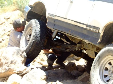 1987 Ford Bronco - Off-roading adventure: 1987 Ford Bronco gets stuck on rocks, requiring attention.