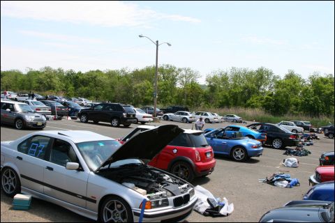 2001 Mercury Grand Marquis - A silver BMW E36 convertible sits with its hood open in a parking lot filled with various vehicles.