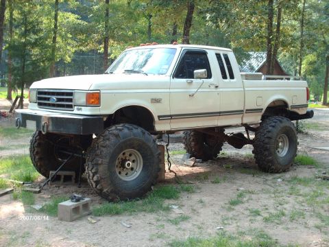 1990 Ford F-150 - This lifted 1990 Ford F-150 features a custom front bumper and massive off-road tires.