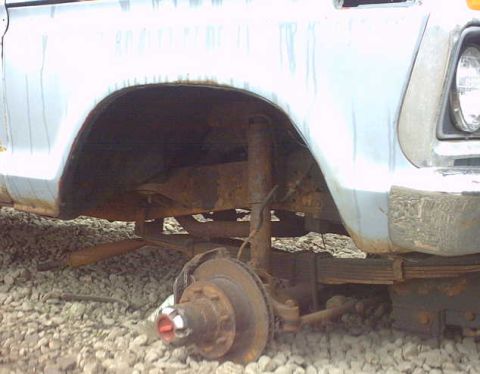 1979 Ford Bronco - Close-up view of a vehicle's wheel and fender, revealing signs of wear and tear.