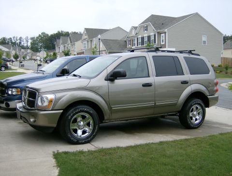 2004 Dodge Durango - This 2004 Dodge Durango is seen in a 3/4 front view, parked alongside a blue pickup truck.
