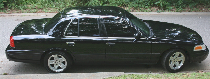 Black 2002 Ford Crown Victoria parked curbside