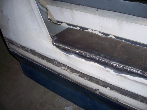 1991 Ford Bronco - Metal panel repair with visible welding on a vehicle's bodywork.