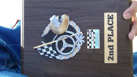 1990 Ford Probe - A trophy awarded for 2nd place, a steering wheel, checkered flag, and helmet emblem.