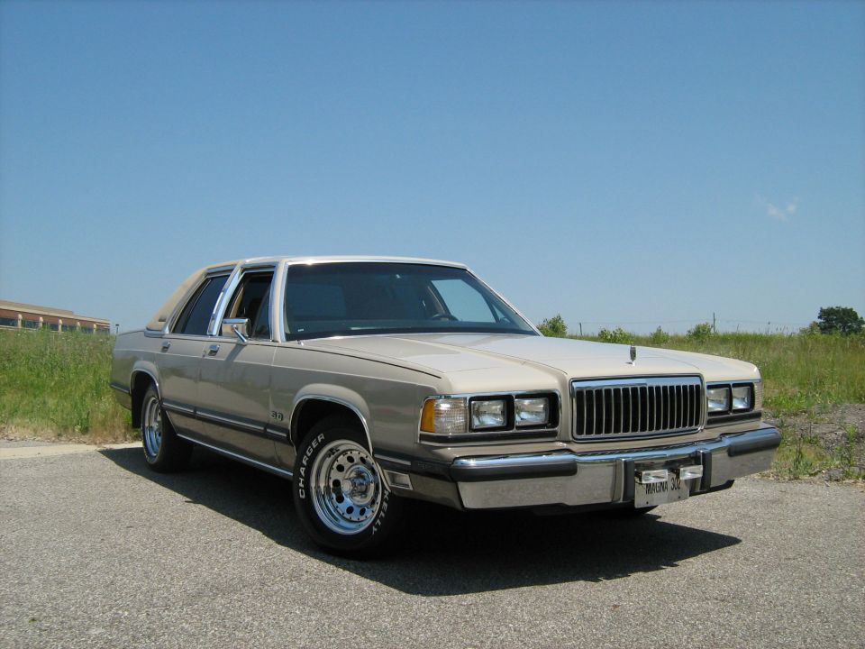 Beige Mercury Grand Marquis front three-quarter in a field