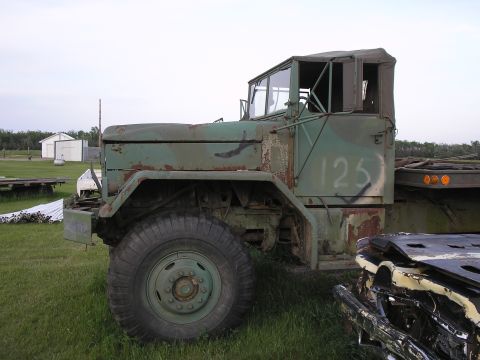 1951 Chevrolet C/K Pickup - Side view of a weathered green military truck parked outdoors.