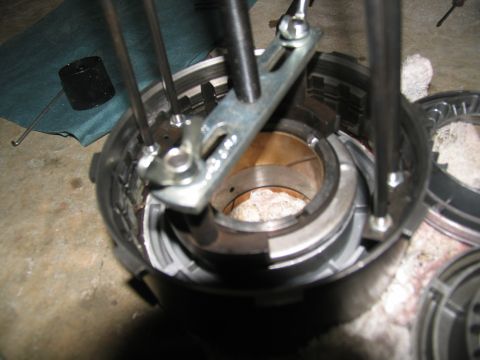 1978 Ford Bronco - Close-up of a transmission component being worked on with a specialized tool.