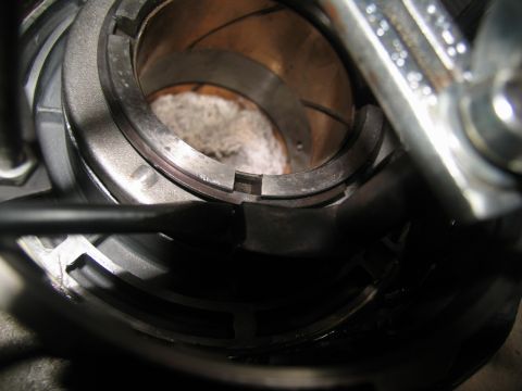 1978 Ford Bronco - A close-up view of a transmission component, possibly a bearing or sleeve, with a tool inserted.